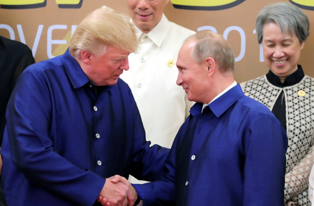 U.S. President Donald Trump and Russian President Vladimir Putin shake hands as they take part in a family photo at the APEC summit in Danang, Vietnam November 10, 2017. Sputnik/Mikhail Klimentyev/Kremlin via REUTERS ATTENTION EDITORS - THIS IMAGE WAS PROVIDED BY A THIRD PARTY.